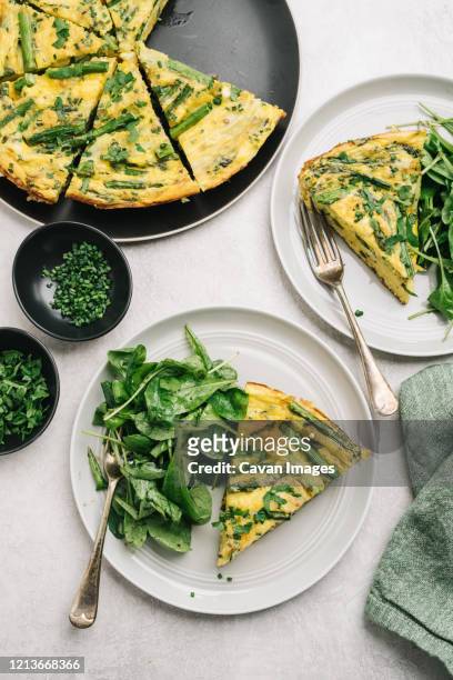 healthy asparagus frittata meal with arugula salad - spinach frittata stock pictures, royalty-free photos & images