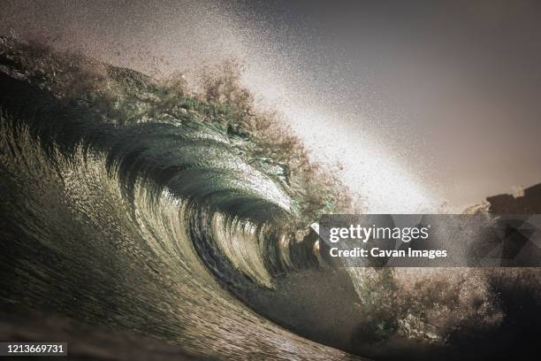 wave barreling on the clear waters of the canary islands, spain. - surf tube stock pictures, royalty-free photos & images