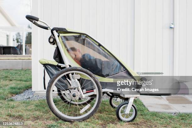 kid sleeping in a stroller outside in sweden - baby products stock pictures, royalty-free photos & images
