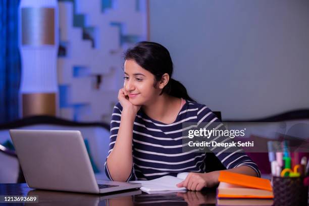 teenager girl doing her homework stock photo - students working on pc school stock pictures, royalty-free photos & images