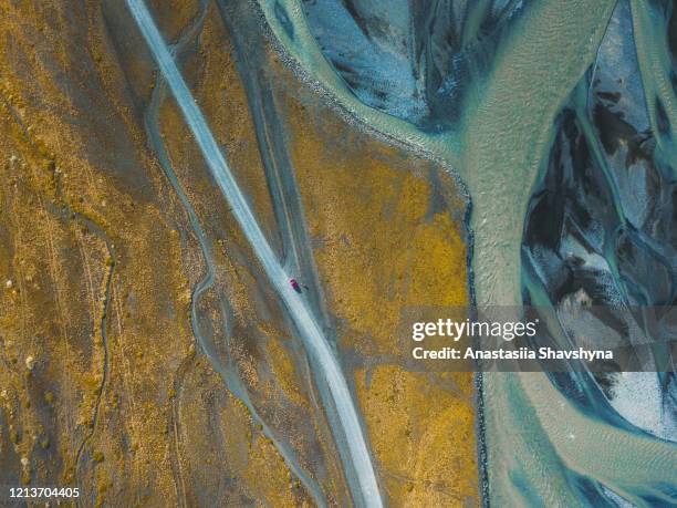 aerial view of the car driving through scenic mountain road near glacier rivers in iceland - snaefellsnes stock pictures, royalty-free photos & images