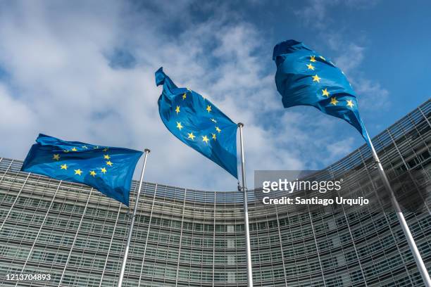 european union flags at berlaymont building - regione di bruxelles capitale foto e immagini stock