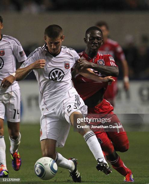 Patrick Nyarko of the Chicago Fire tries to hold back Perry Kitchen of D.C. United during an MLS match at Toyota Park on August 18, 2011 in...