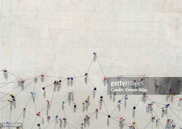 crowd from above forming a growth graph - people stock pictures, royalty-free photos & images