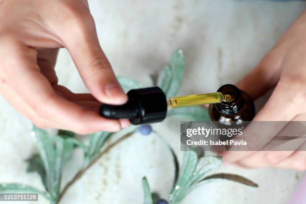 woman hands holding pipette of essential oil - hair products ストックフォトと画像