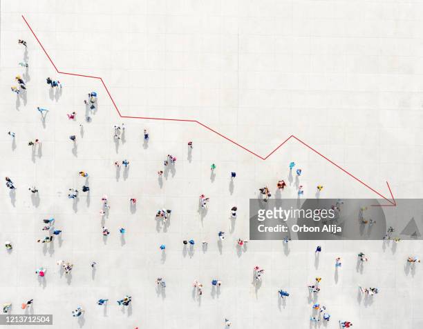 crowd from above forming a falling chart - economy stock pictures, royalty-free photos & images