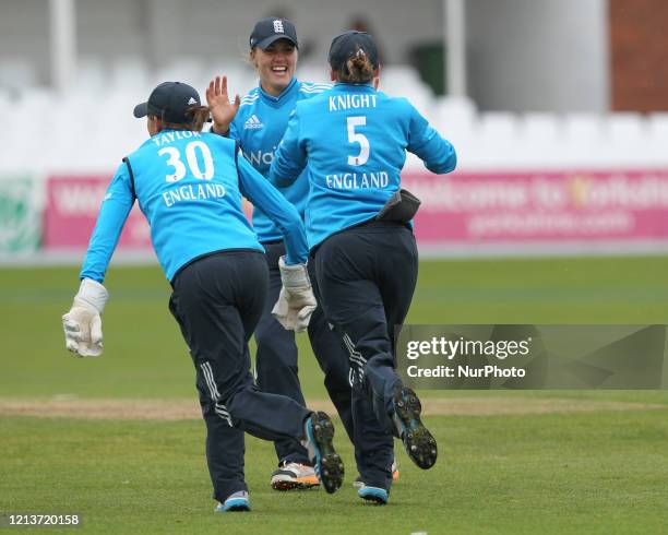 England's Sarah Taylor and Natalie Sciver celebrate Karu Jain's dismissal with Heather Knight during the First One Day International between England...