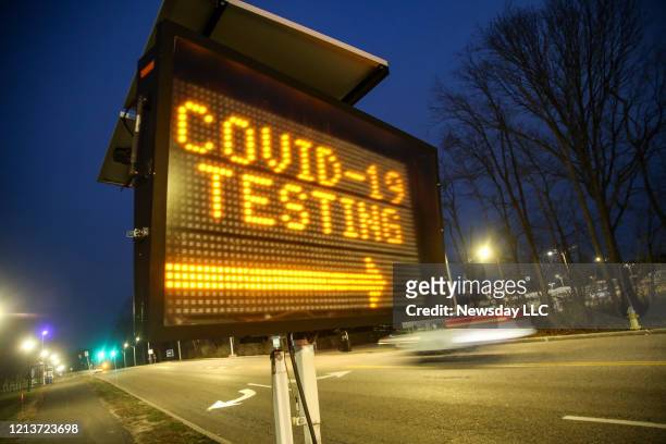 Digital sign directs people to the drive-through coronavirus testing area which began on the main campus of Stony Brook University on March 18, 2020....