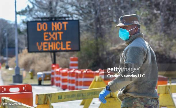 Member of the National Guard is in position to direct traffic as drive through coronavirus testing was set to began shortly after noon on March 18 in...