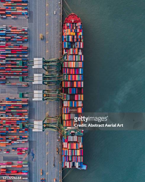 large container ship being loaded in port as seen from above, netherlands - moored stock pictures, royalty-free photos & images