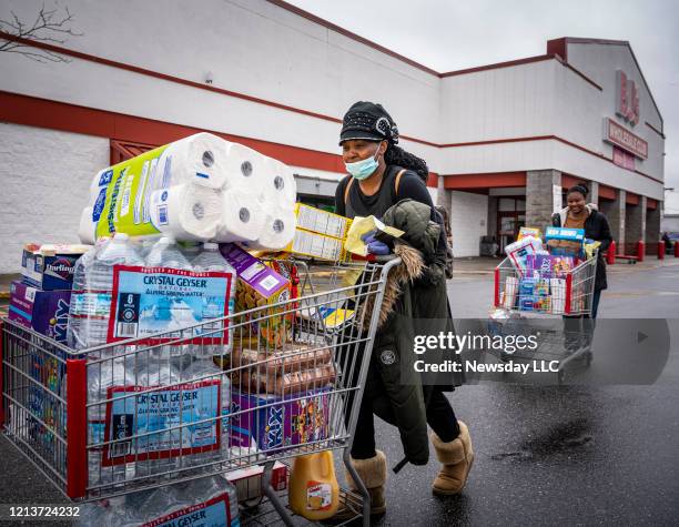 Freeport residents Cortia Morris and her daughter Lashae Haughton leaving BJ's Wholesale Club in Freeport,New York after getting water and paper...