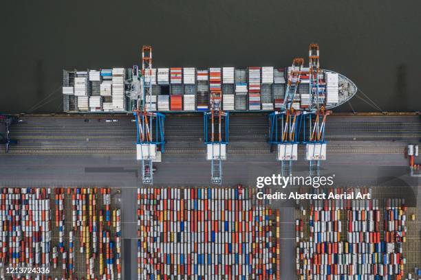 aerial shot above a cargo ship loading crates, germany - bremerhaven stock-fotos und bilder