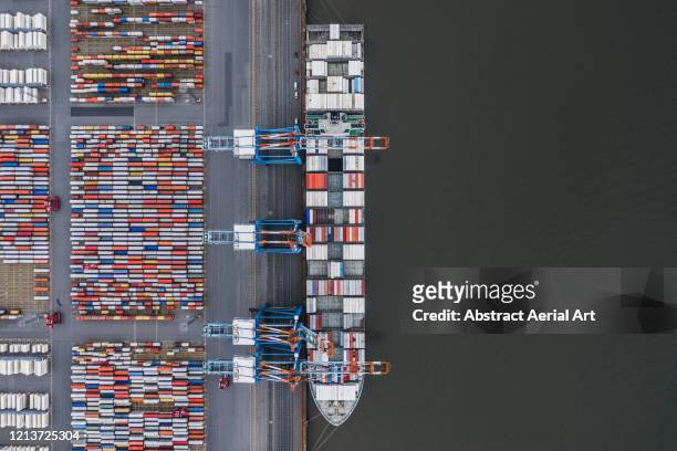 container ship docked in port as seen from above, germany - freight transportation stock-fotos und bilder