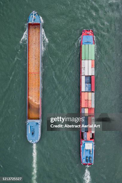 aerial image showing two industrial ships side by side in the rhine river, karlsruhe, germany - barge stock-fotos und bilder