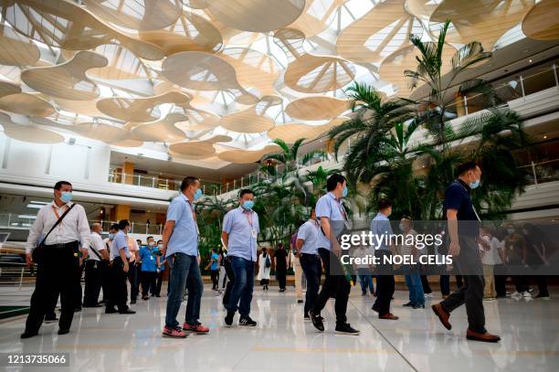 Huawei employees walk along the hallway of a building at the Huawei headquarters in Shenzhen in China's southern Guangdong province on May 19, 2020....