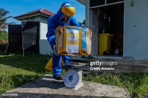 Waste officer transports hazardous medical waste from a referral hospital for COVID-19 patients in Pekanbaru, Riau Province, Indonesia on May 19,...