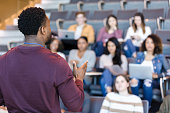 Male college professor gestures during lecture