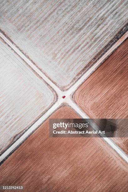 top down aerial view of two dirt roads crossing spanish farmland, spain - crossroad fotografías e imágenes de stock