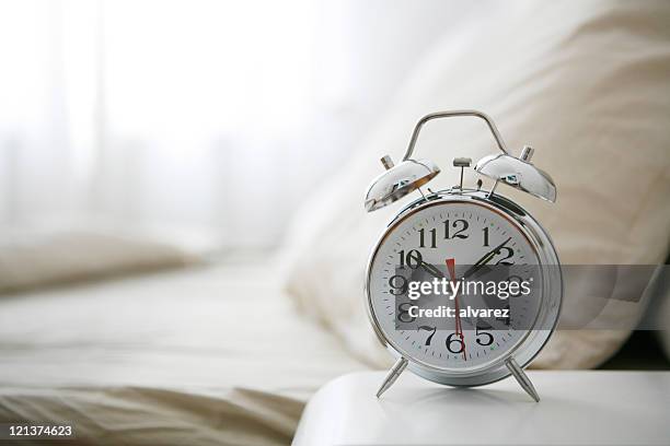 alarm clock on bedside table - second chance stock pictures, royalty-free photos & images