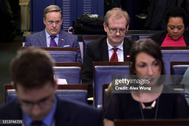 Former White House Press Secretary Sean Spicer sits among members of the press as he waits for the beginning of a news briefing on the latest...