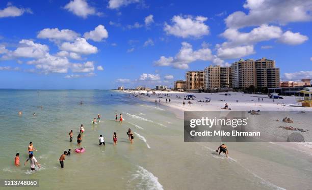 People visit Clearwater Beach during the coronavirus pandemic March 20, 2020 in Clearwater, Florida. The World Health Organization declared COVID-19...