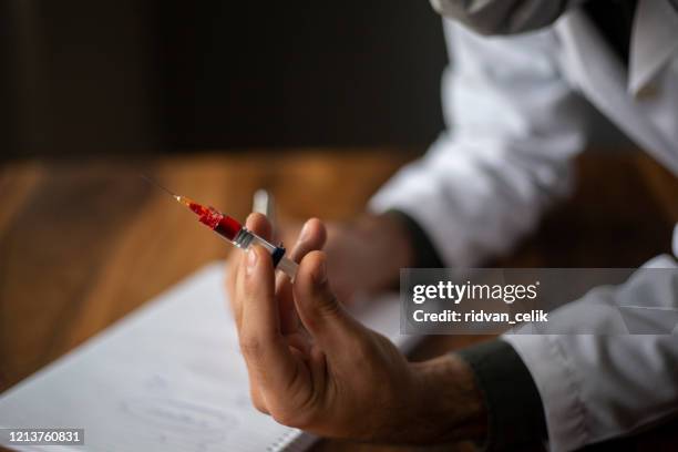 close up of syringe and blood vaccine dripping - fentanyl stock pictures, royalty-free photos & images