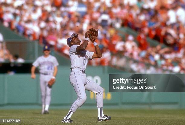 Harold Reynolds of the Seattle Mariners tracks a pop-up against the Boston Red Sox during an Major League Baseball game circa 1987 at Fenway Park in...