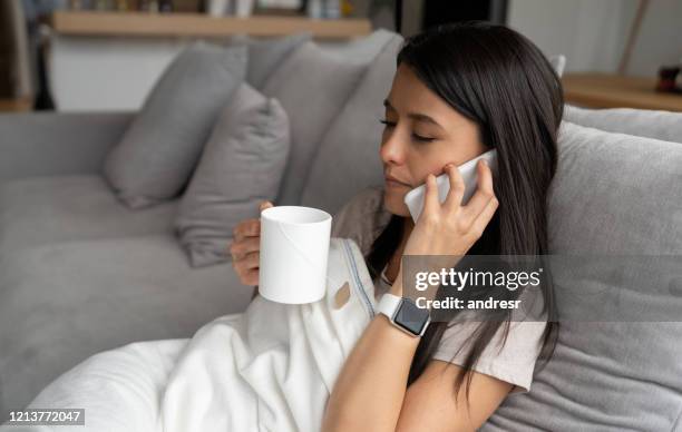 sick woman in quarantine at home - sick person on phone stock pictures, royalty-free photos & images