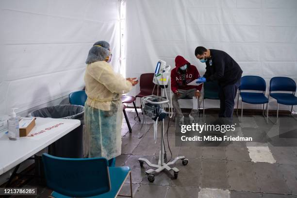 Juan Vasquez registers for a COVID-19 test inside a testing tent at St. Barnabas hospital on March 20, 2020 in New York City. St. Barnabas hospital...