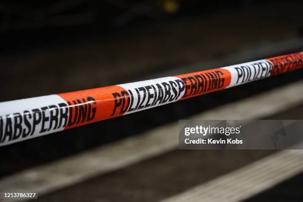 barrier tape of the german police with rain drops at a train station in berlin, germany. - recinto foto e immagini stock