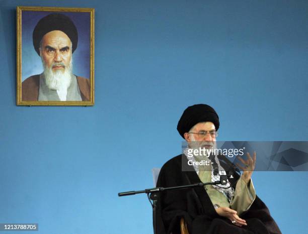 Iranian supreme leader Ayatollah Ali Khamenei delivers his speech under a portrait of Iran's late founder of Islamic Republic, Ayatollah Khomeini in...