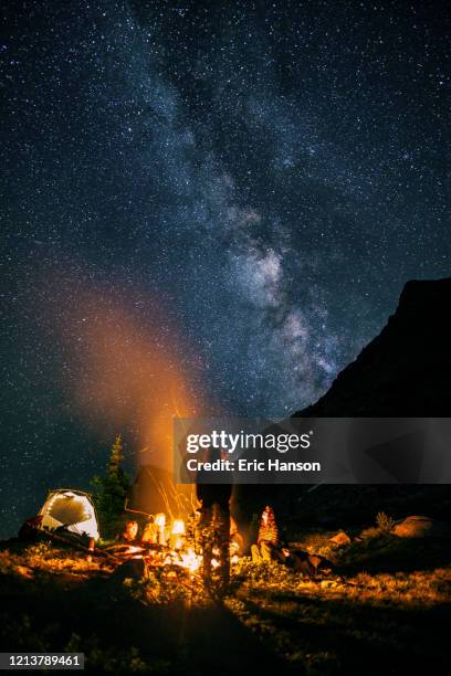 campers enjoy a campfire under milky way - wyoming stock pictures, royalty-free photos & images