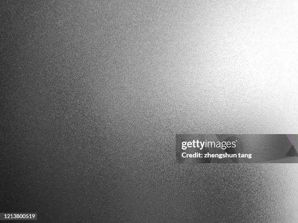 side lit matte metallic texture - grijswaarden stockfoto's en -beelden