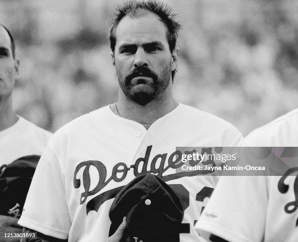 Kirk Gibson of the Los Angeles Dodgers stands during the national anthem before the NLCS game against the New York Mets at Dodger Stadium, Los...