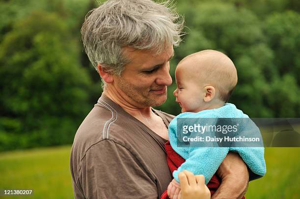 father holding baby son - moulsford stock pictures, royalty-free photos & images