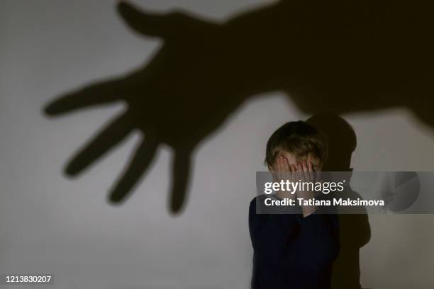 little boy and scary shadow of hand - scared boy imagens e fotografias de stock