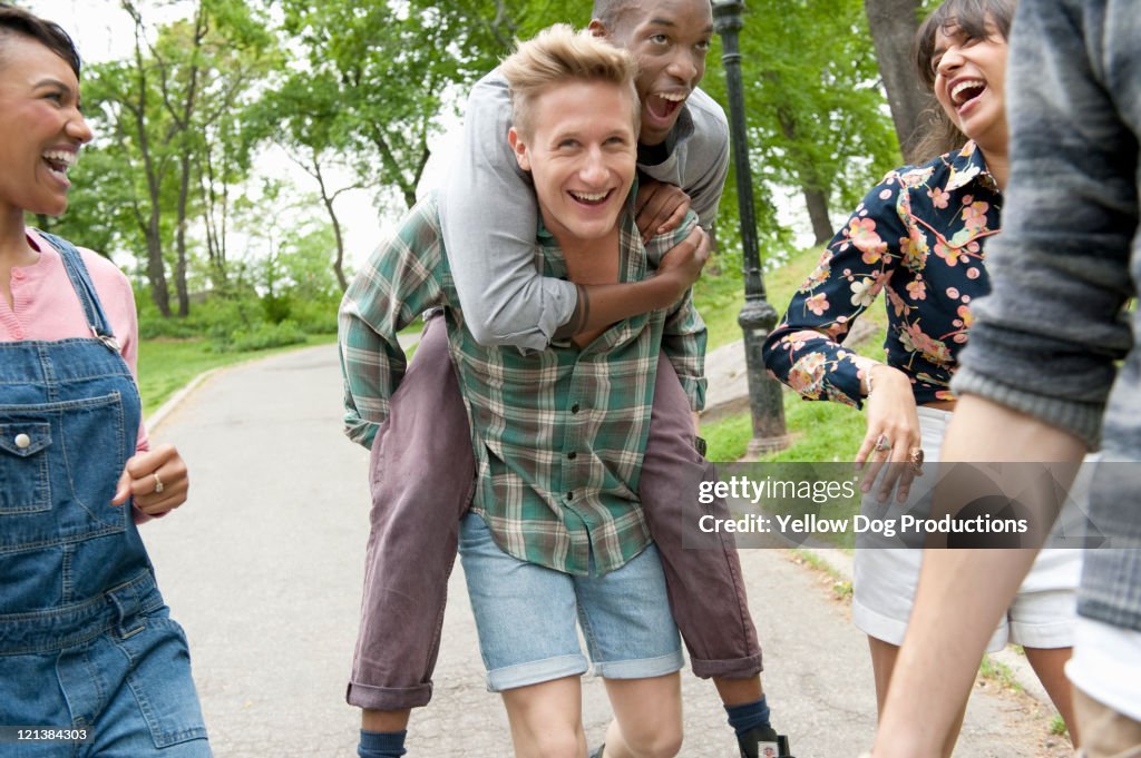 Group of young adult friends playing in the park