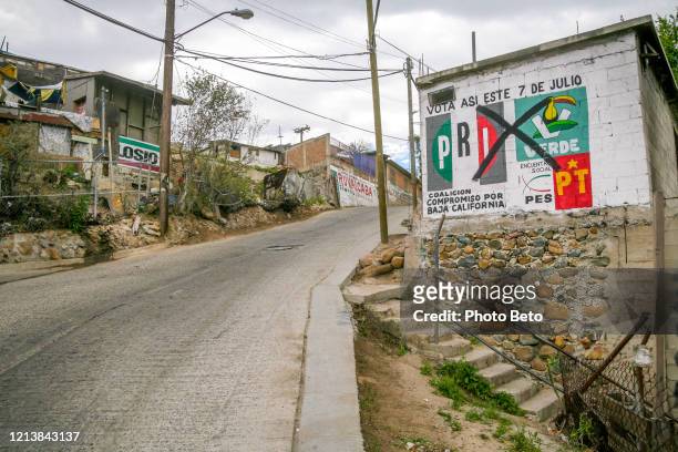 an old election announcement in a street of lomas taurinas in tijuana - mexico slums stock pictures, royalty-free photos & images