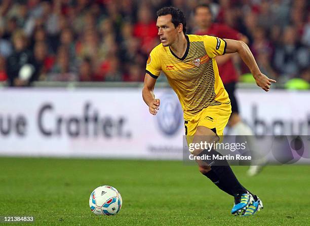 Piotr Trochowski of Sevilla runs with the ball during the UEFA Europa League play-off match between Hannover 96 FC Sevilla at AWD Arena on August 18,...