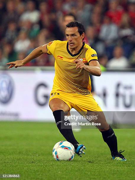 Piotr Trochowski of Sevilla runs with the ball during the UEFA Europa League play-off match between Hannover 96 FC Sevilla at AWD Arena on August 18,...