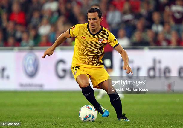 Piotr Trochowski of Sevilla runs with the ball during the UEFA Europa League play-off match between Hannover 96 FC Sevilla at AWD Arena on August 18,...