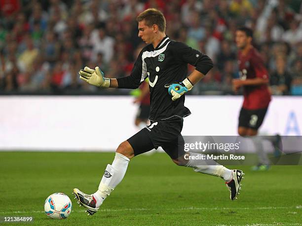 Ron Robert Zieler, goalkeeper of Hannover plays the ball during the UEFA Europa League play-off match between Hannover 96 FC Sevilla at AWD Arena on...