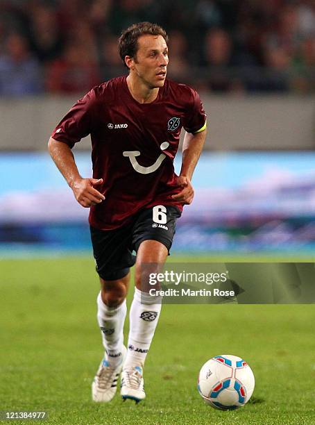 Steven Cherundolo of Hannover runs with the ball ball during the UEFA Europa League play-off match between Hannover 96 FC Sevilla at AWD Arena on...