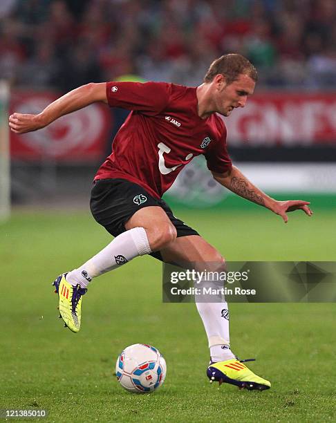 Konstantin Rauschof Hannover runs with the ball ball during the UEFA Europa League play-off match between Hannover 96 FC Sevilla at AWD Arena on...