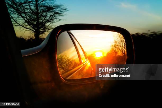 view of a car wing mirror. sunset time - side view mirror foto e immagini stock