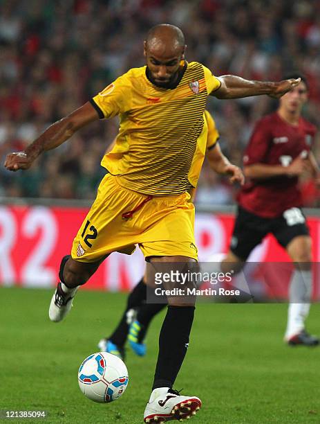 Frederic Kanoute of Sevilla runs with the ball during the UEFA Europa League play-off match between Hannover 96 FC Sevilla at AWD Arena on August 18,...