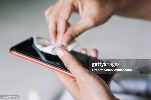 cleaning smart phone - pathogen stock pictures, royalty-free photos & images