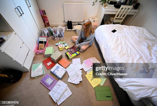 Year eleven student Tilly Mason ponders over her school books and revision materials after an unexpectedly premature end to her school year due to...