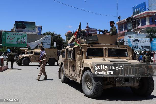 Afghan security forces sit in a Humvee vehicle amid ongoing fighting between Taliban militants and Afghan security forces in Kunduz on May 19, 2020....