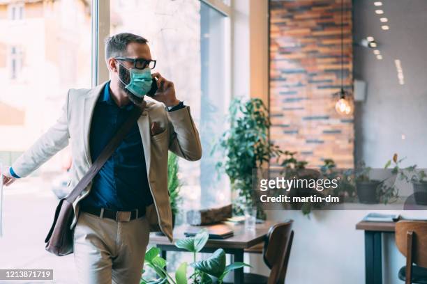 businessman with protective mask during covid-19 - entering stock pictures, royalty-free photos & images